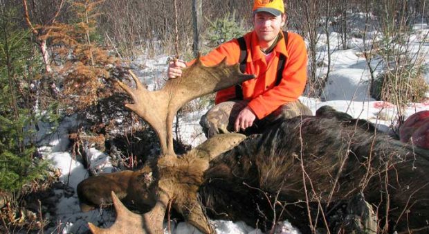 snow - Man with a harvested moose