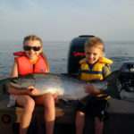 Hannah, 9, and Colton Primrose, 5, holding a giant salmon on Lake Ontario.