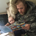 Some people read children's books to their kids. Jackson Beau, 7 weeks, prefers fishing articles.