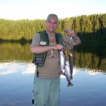 Tony Geden showing off his share of the catch on his first lake trout fishing expedition.