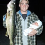 "A proud moment for dad, Justin Hawn, of North Bay, Ontario as he holds an 11 pound walleye in one hand while cradling his one-month-old son Jayven in the other. Jayven was half the size of the catch, weighing 5.5 pounds."