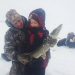 Rob Matthews with six-year-old son Keegan. It was Keegan’s first time ice fishing. It took five minutes to hook this 27-inch northern pike and another 10 minutes of fighting before the fish was pulled from the hole.