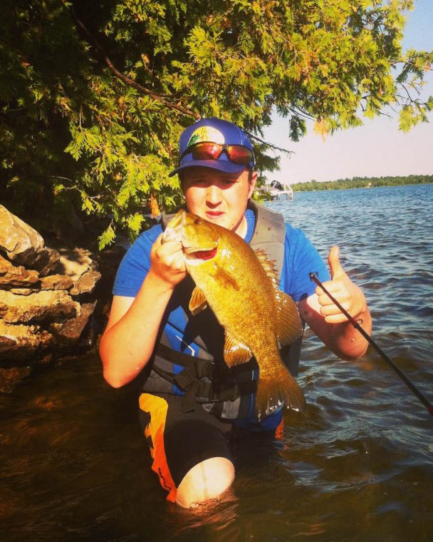 keegan - boy holding a fish