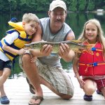 Dean Young of Fort Erie displays a northern pike he caught with children Brett and Karisa Young.