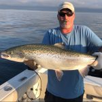 Phil Zywot of Toronto celebrates catching this trophy Lake Ontario Atlantic salmon.
