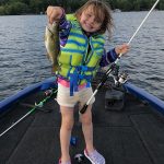 Kara Liscombe of Coboconk holds up a smallmouth bass while fishing with her dad.