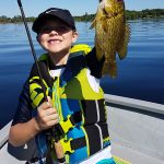 Landon Hopwood, 7, of Ottawa was all smiles after his first catch of the day while fishing with his grandfather Douglas on Calabogie Lake.
