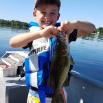 Tristan Hopwood, 6, of Ottawa was excited about the smallmouth bass he caught while fishing with his grandfather Douglas on Calabogie Lake.