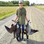 Isaac Kirby of Iron Bridge displays the harvest of his first goose hunt with his dad and uncle.