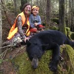 Laura McPhee and her son Griffen McPhee of Guelph with a bear Laura harvested on Manitoulin Island.