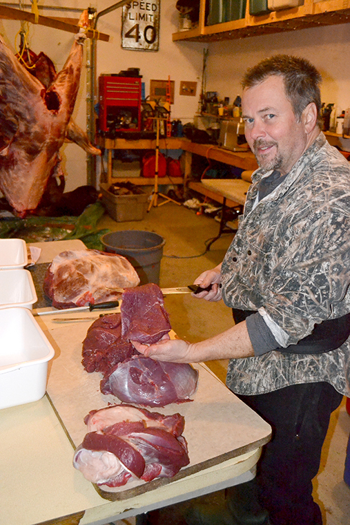 man butchering moose