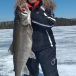 Loretta Bilous of Dryden caught this giant lake trout with a friend on a 10-lb test line through an eight-inch hole in northwestern Ontario.