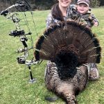 Shannon Kelly of Napanee shows off her bow-harvested 23-lb tom to her daughter, Bailey.