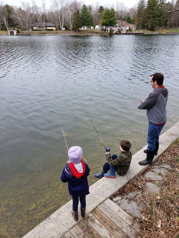 family fishing on breakwall