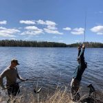 Deven Trist of Dryden and Josh Smith celebrate a trout catch in Dryden.