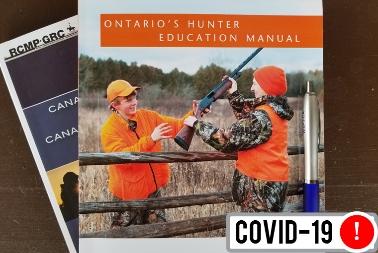 Ontario Hunter Education Program manual with a pen.