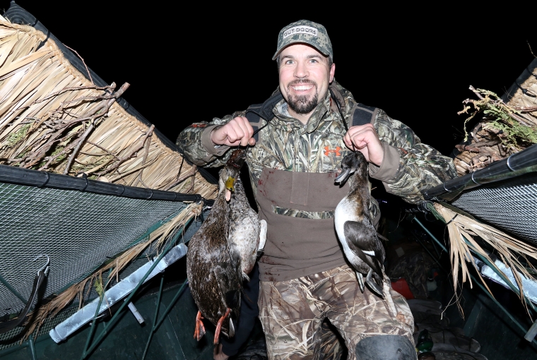 a waterfowl hunter in the blind