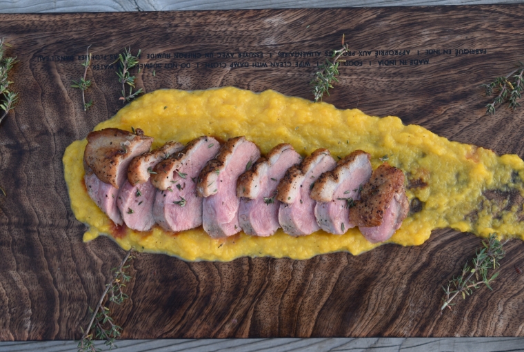 Pan-seared mallard medallions served on a smear of butternut squash puree, garnished with thyme