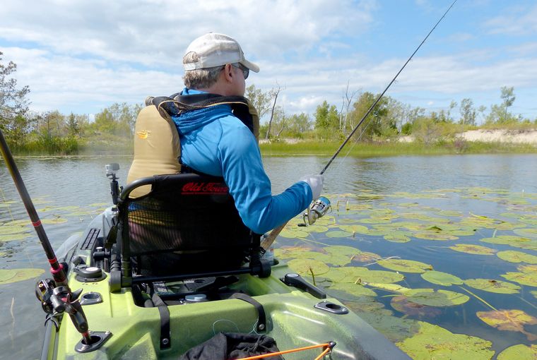 An angler fishes for bass from a kayak