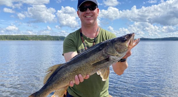 Man holds walleye