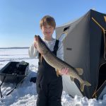 Max Moreau of Waubaushene, 7, holds his first pike caught while ice fishing on Georgian Bay with his father, Ryan Moreau.