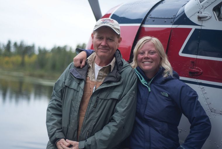 Pilot and family smiling near plane