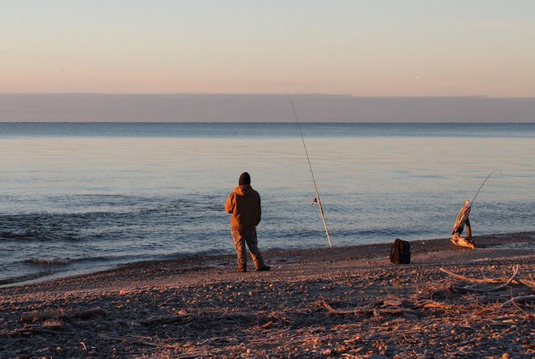 An angler fishing the frog waters at the mouth of a Lake Ontario tributary