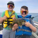 Blair Duhamel of Eden was trolling for pike with his boys on the Inner Bay of Long Point when his son Quintin caught this 11-inch rock bass on a three-inch floating jointed Rapala. His younger brother Lucien was happy to help by netting the monster into the boat.