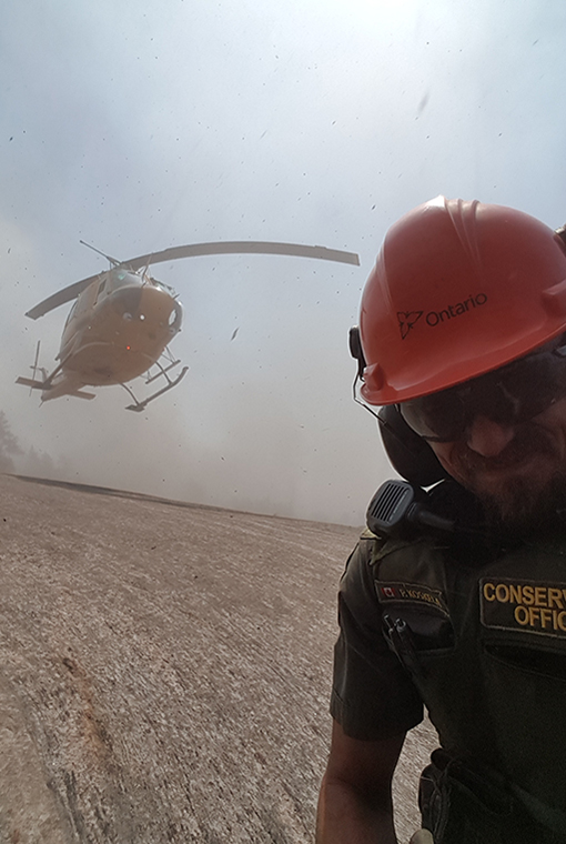 CO Peter Koskela taking a selfie near a helicopter