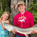 Ten-year-old Ayda Naylor of Swastika landed this 15-pound pike while fishing with friends and family from the shoreline of Lake Abitibi. Her older sister Mikayla helped to hold the gator as their proud father Pete snapped a photo.