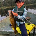 Erik Knutsen of Kingston was fishing with his nine-year-old son Kai [and Kai’s Obi] on a secret lake near Quetico Park in northwestern Ontario, when Kai caught this walleye.