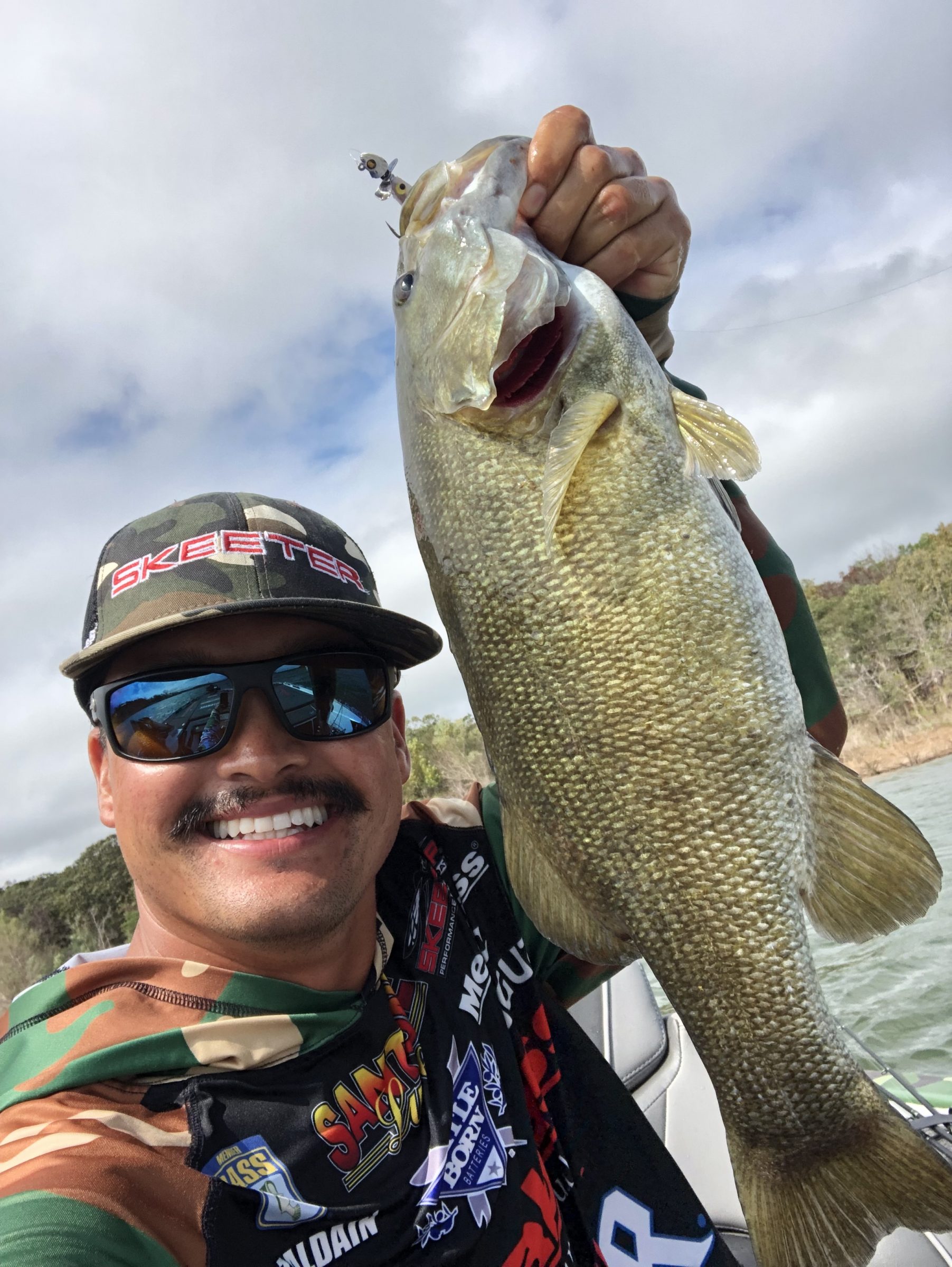 Chris Zaldain holding a smallmouth bass