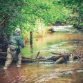 an angler peers into the river