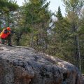 man crouched on a rock