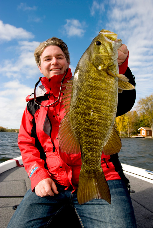 Man Holding A Bass Fish