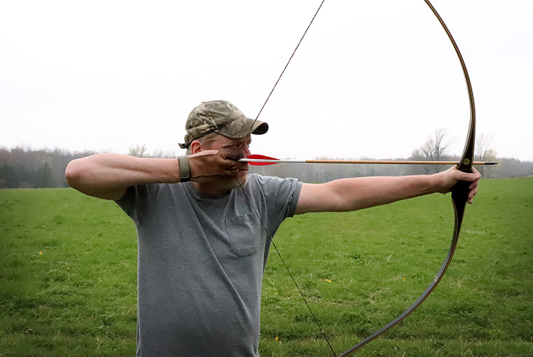 Man Holding Bow & Arrow