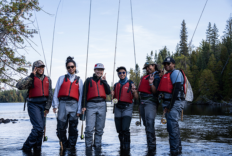 Brown Girl Outdoor World group of ladies with fly rods in a waterbody