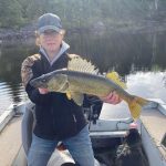Jackie Rocca of Sudbury caught and released this Lake Nepewassi walleye near Sudbury at the end of May. Lemmy the lab photo-bombed while going in for a lick of fish slime.