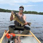 Edward McCarthy with a 31-inch walleye caught using a blue crankbait while trolling in a canoe.