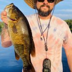 Ryan Downey of Petawawa with a smallmouth bass that was caught and released. It was caught using a six-inch wacky rigged plastic bait.