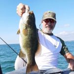 Angelo Lauricella poses with a bass he caught on Lake Erie.