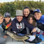 Alexander Brown of Windsor with family after the last cast of the trip finally landed the pike they had been chasing all week. They screamed so loud that the entire lake came out to see.