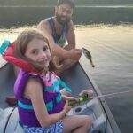 BJ Valade of St. Thomas pictured with daughter Ivy. She caught a little bass on her first cast while canoeing at Awenda Provincial Park.