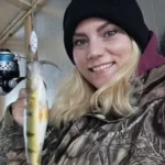 Eva Sakure of Mississauga was fishing for the very first time on Lake Simcoe when she caught this perch. She is hooked for life.