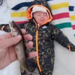 Jennifer Neureuther submitted a photo of baby Edmund who went ice fishing at camp with his parents and “caught” a lake trout almost as tiny as him!