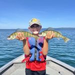 Calvin Pitt of Sault Ste. Marie and his son Hunter (shown) with a couple of Lake Superior jumbo perch.