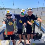 Krista Henricks of South Woodslee records three friends who’ve been bass fishing every day while on vacation on Pike Bay, Lake Huron. From left are Emerson Henricks, Grady Alexander, and Waylon Henricks.