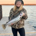 Chanelle Hass of Providence Bay with her Lake Huron fall rainbow caught off a dock.